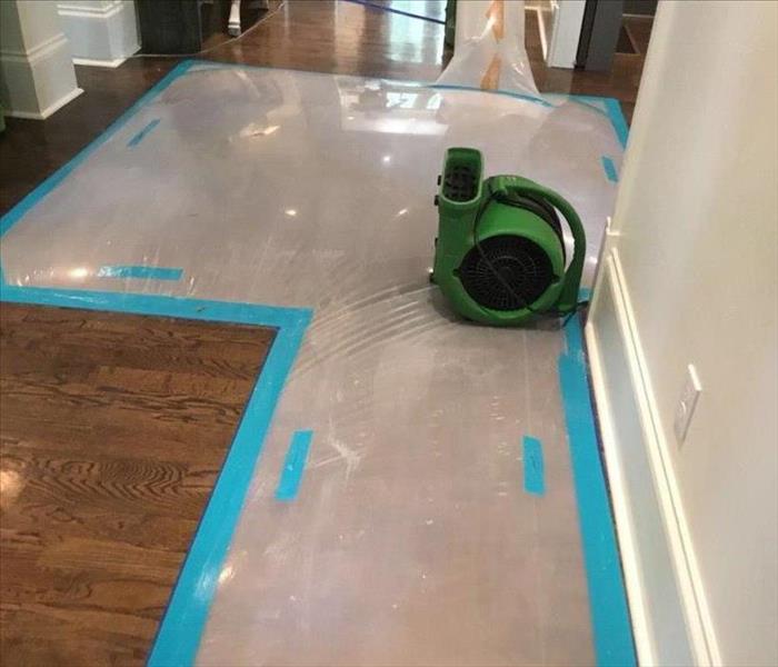 Air movers on a hardwood floor in a home