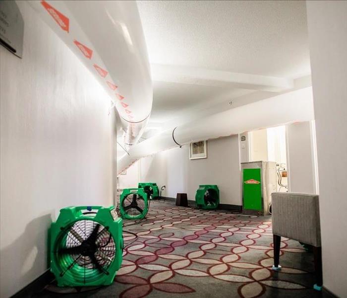 SERVPRO drying equipment set up in the hallway of a hotel