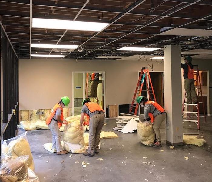 SERVPRO technicians cleaning up office after a severe water leak