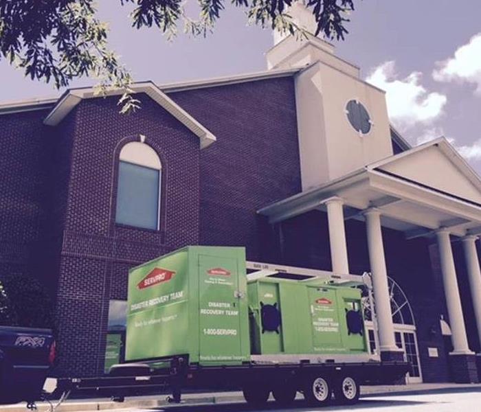 SERVPRO trucks and equipment in front of a school